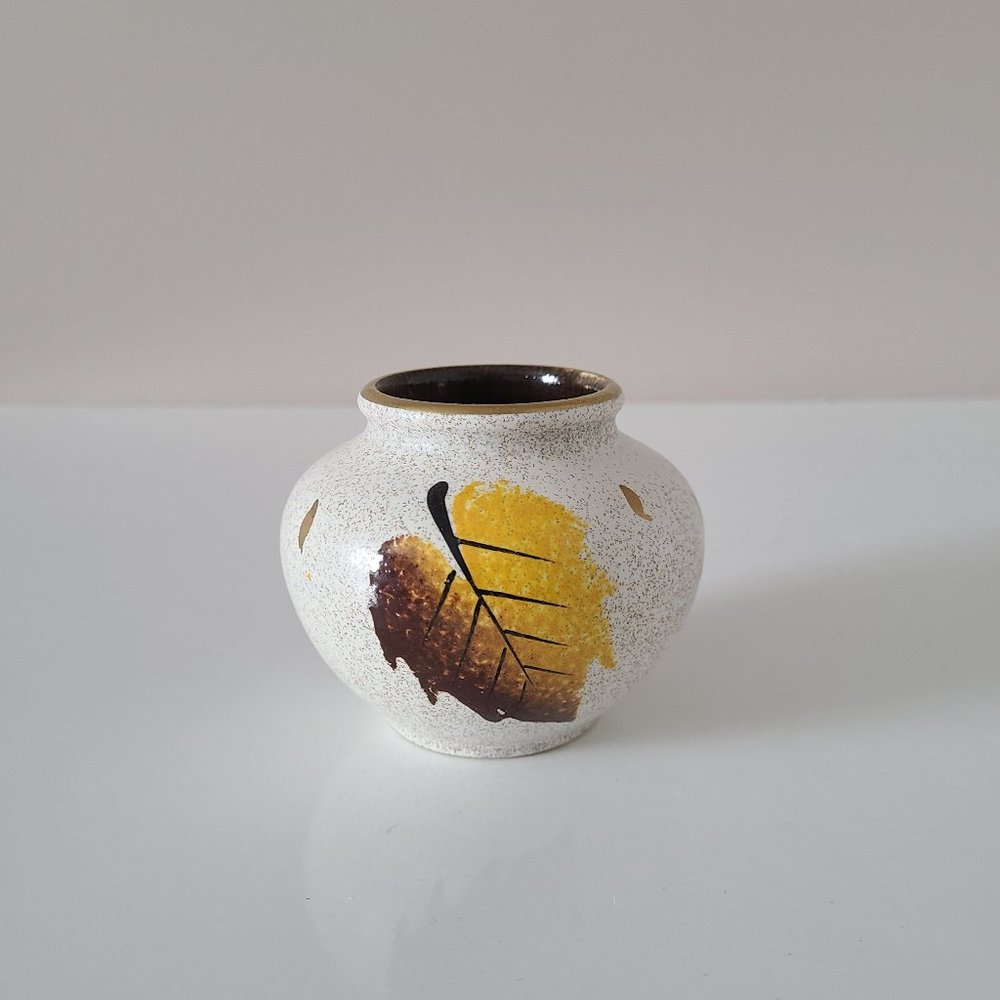 Little ceramic round hand painted vase with leaves design.